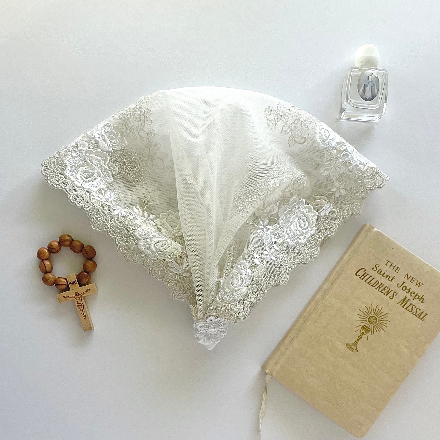 Ivory-colored lace veil with rose embroidery. The mantilla is perfect for Traditional Catholic Mass or Christian baby baptism