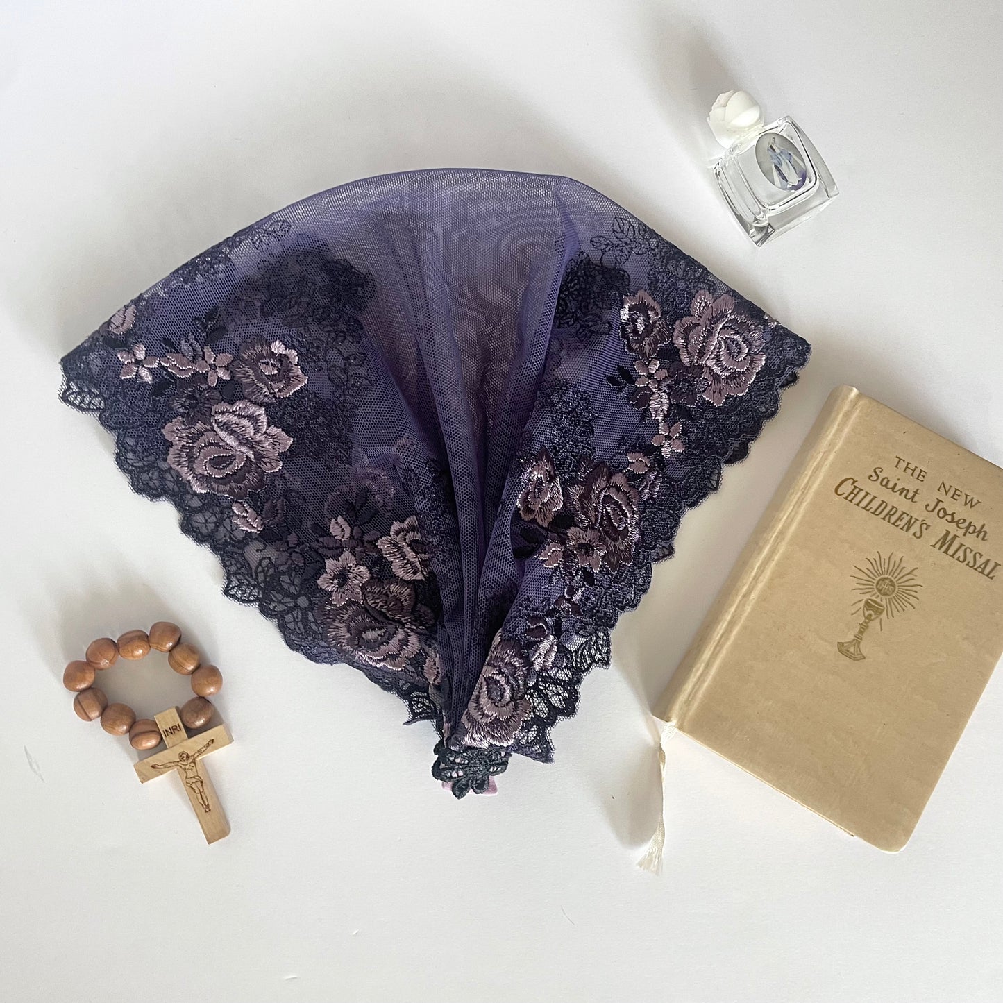 Dark purple lace veil with rose embroidery. The baby or toddler mantilla is perfect for Traditional Catholic Christian Mass