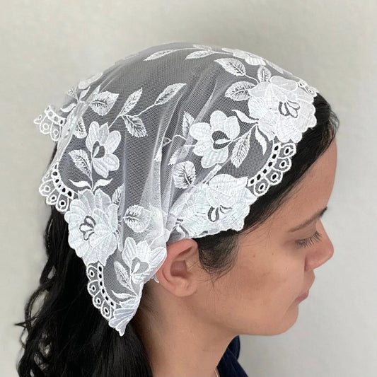 Girl wearing a small beautiful white embroidered lace chapel veil kerchief.