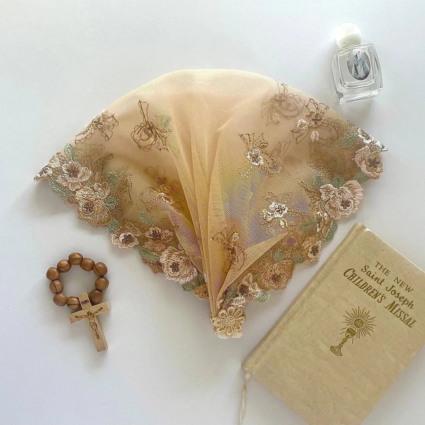 Child beige lace chapel veil featuring delicate embroidered floral pattern.