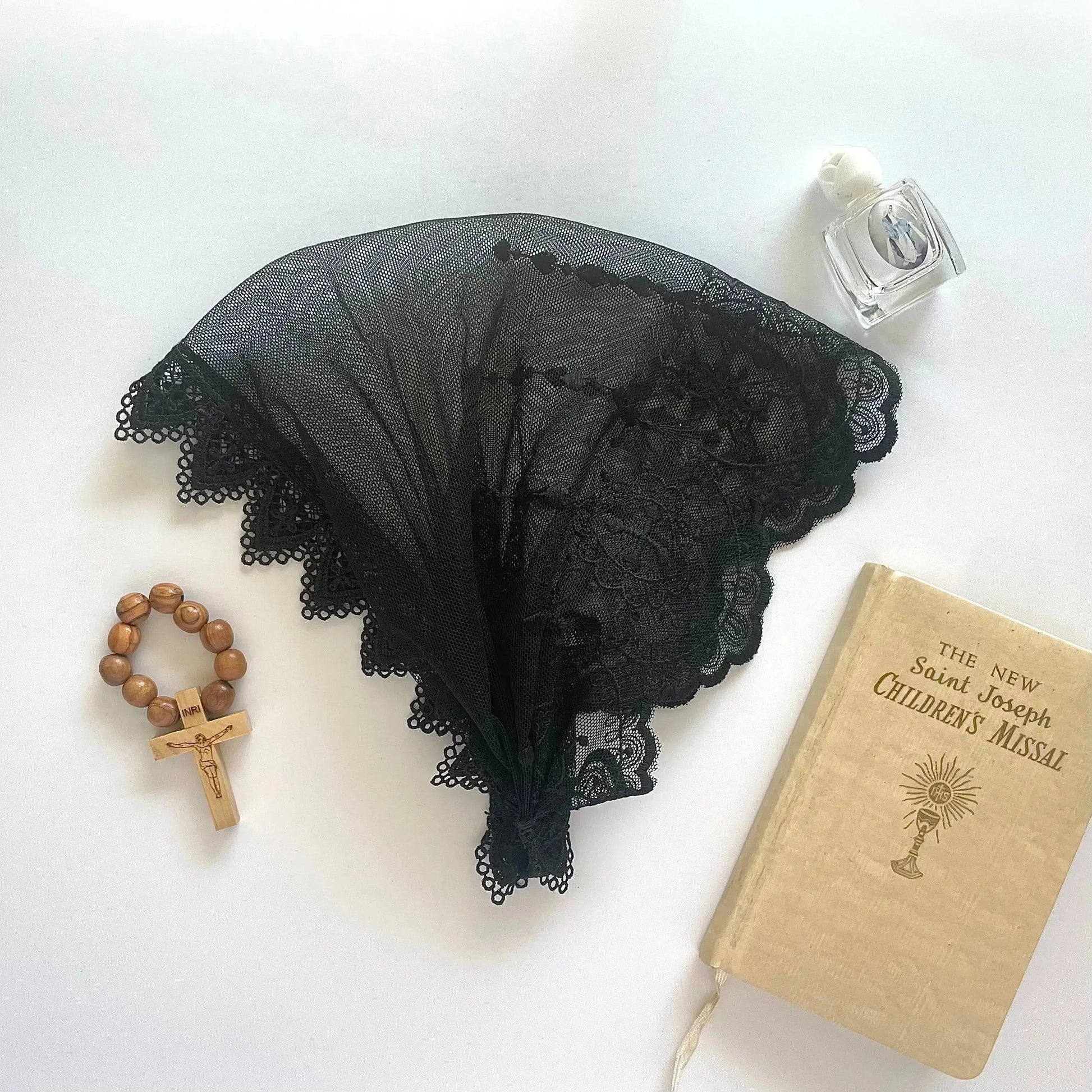 Infant black lace chapel veil headband for a traditional Catholic.