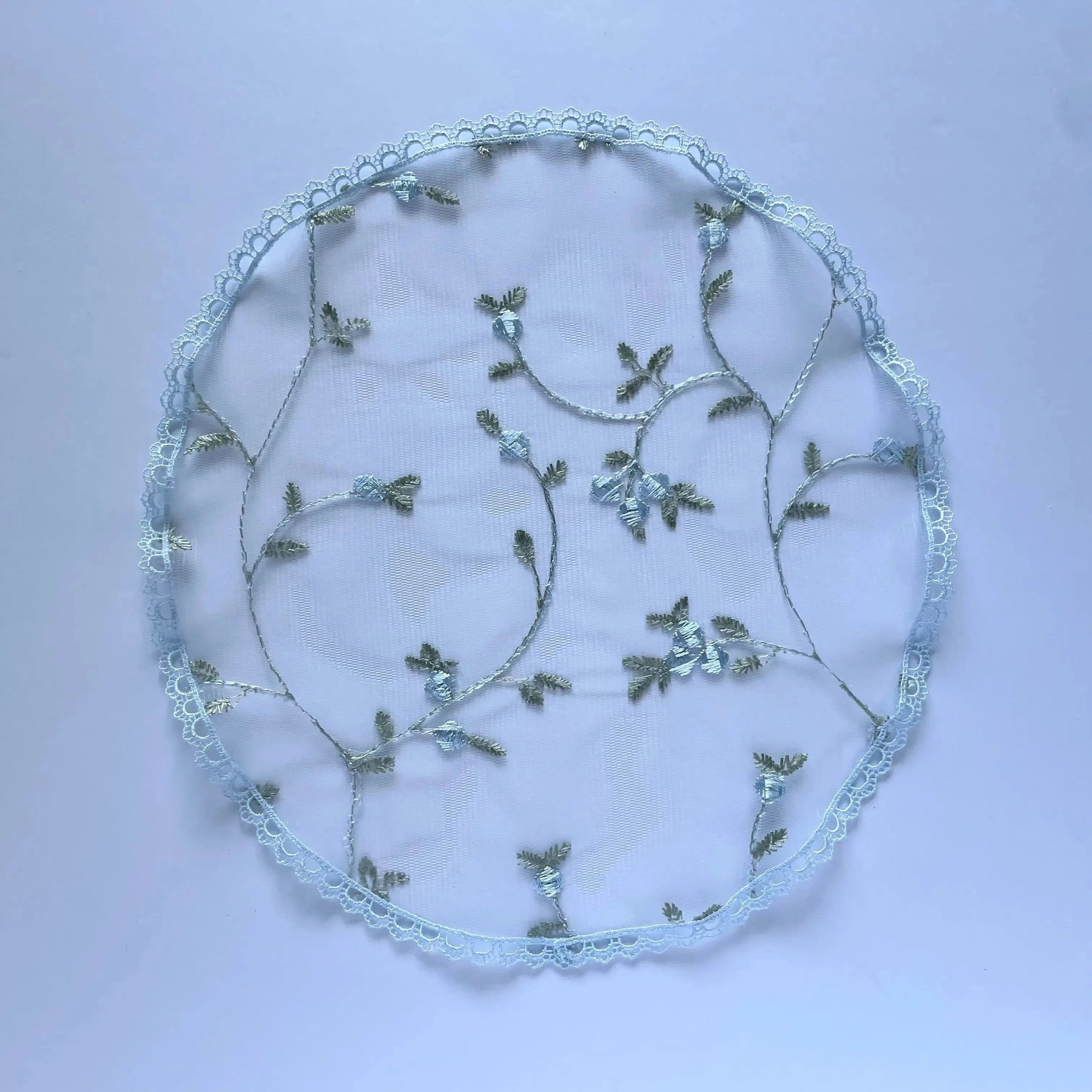 Traditional circular chapel veil, a blue embroidered lace cap for a little girl. 