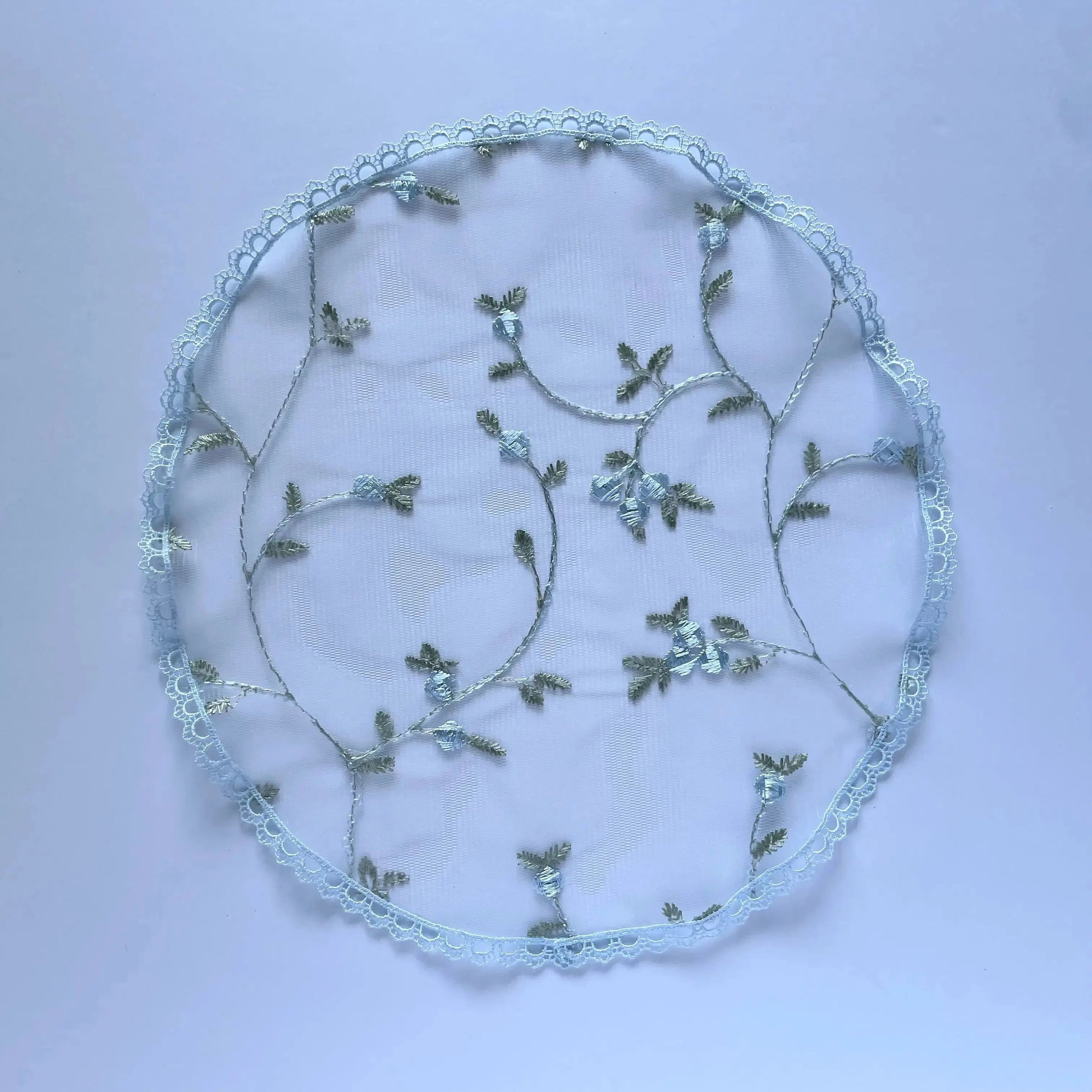 Traditional circular chapel veil, a blue embroidered lace cap for a little girl. 