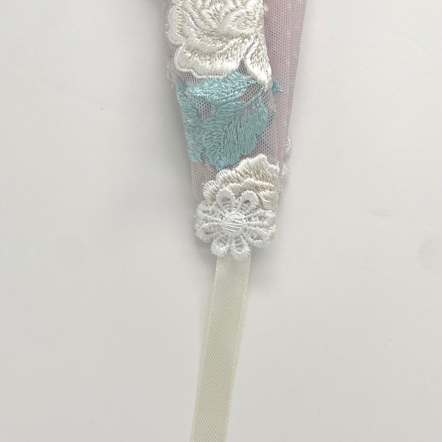 Lace chapel veil with ribbon ties and ivory trim. The small girls veil headband also acts as a kerchief bandana. 
