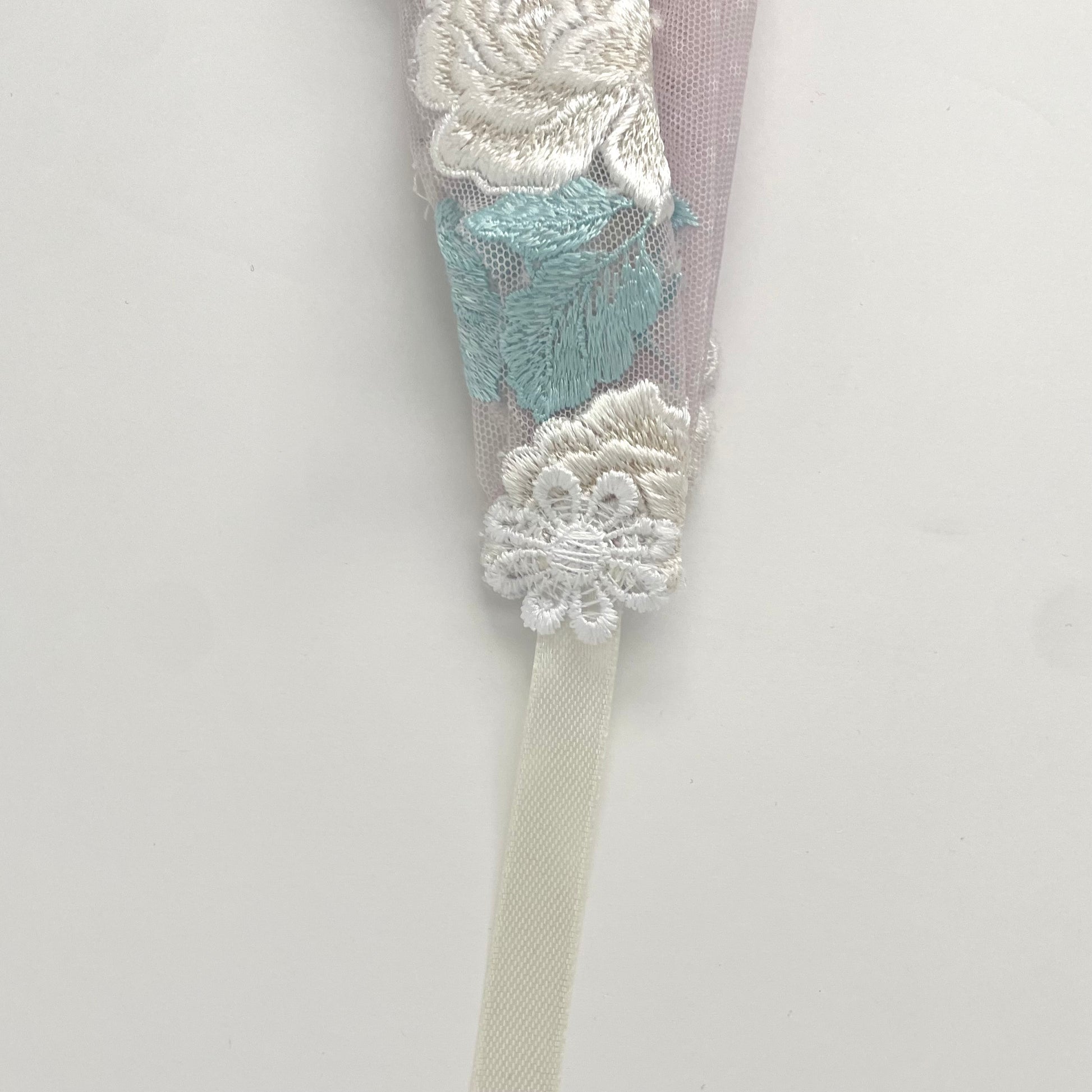 Lace chapel veil with ribbon ties and ivory trim. The small girls veil headband also acts as a kerchief bandana. 