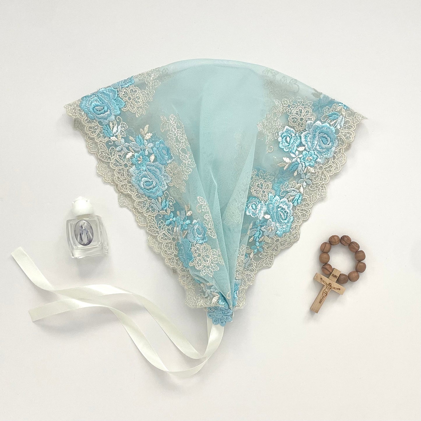 Light blue lace chapel veil with rose embroidery. The small girl mantilla is perfect for Traditional Catholic Christian Mass