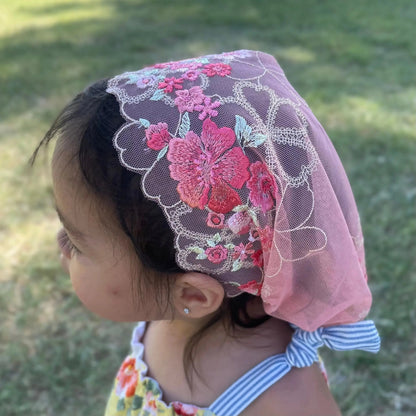 Toddler's top view, highlighting the floral embroidered lace detailing on a Christian chapel veil.