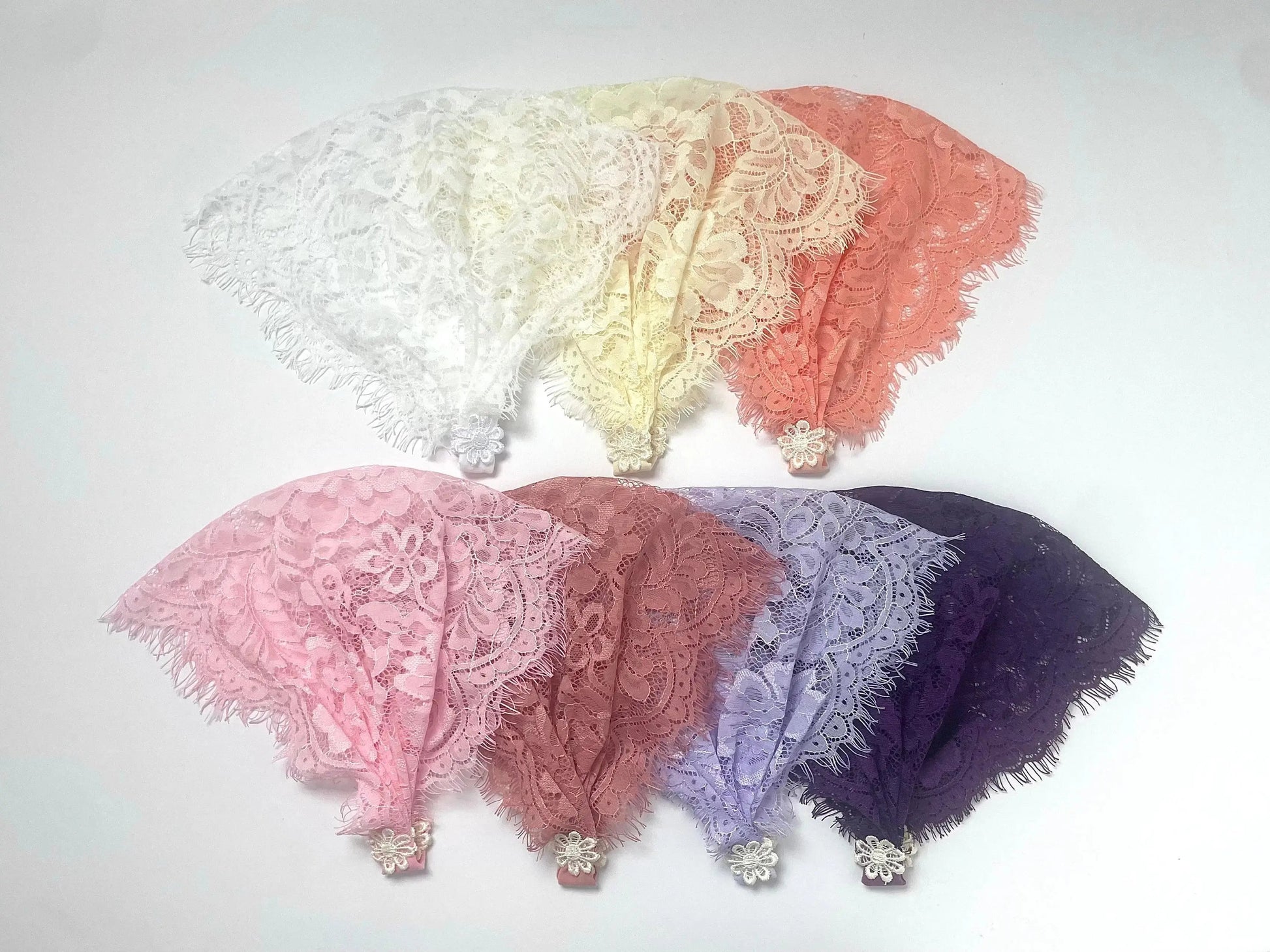 Infant eyelash lace veils in a variety of colors for a traditional Catholic mass.