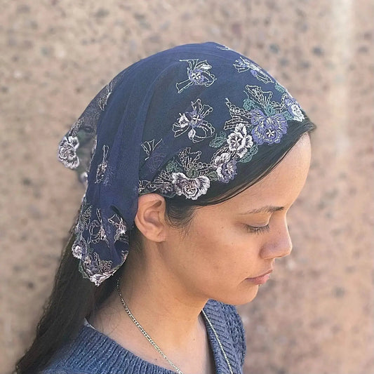 Woman wearing a dark blue Traditional Catholic Mass Veil.