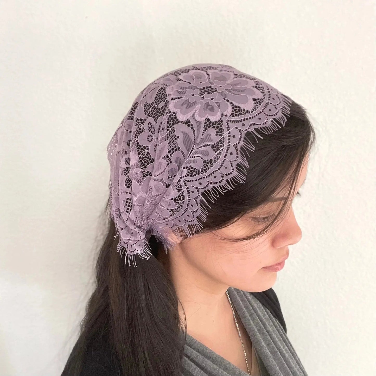 Woman wearing a small purple headscarf chapel veil. Perfect for daily mass during the Catholic Lenten liturgical season..