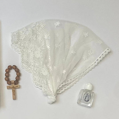 Infant white lace chapel veil headband for a traditional Catholic ceremony.