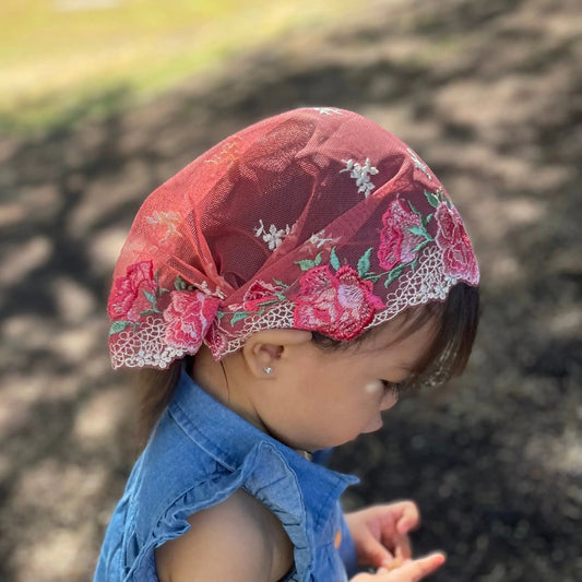 Red pink embroidered lace traditional chapel veil for a christian toddler.