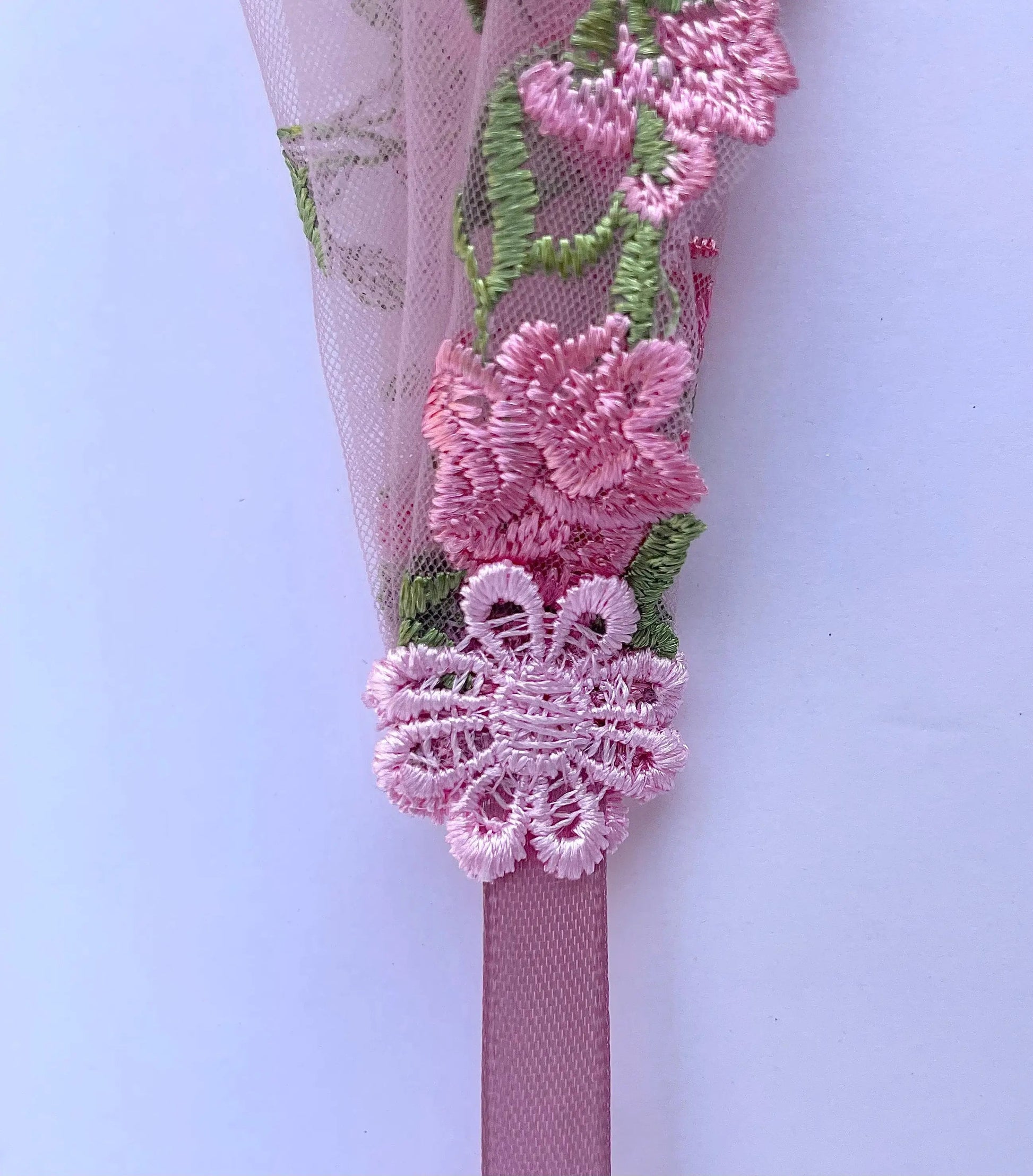 Pink lace chapel veil with ribbon ties and rose embroidery. The small girls veil headband also acts as a kerchief bandana.