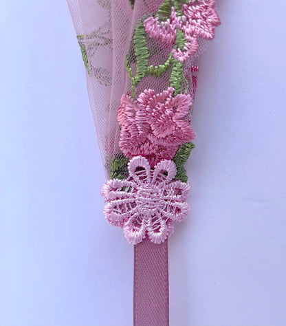 Pink lace chapel veil with ribbon ties and rose embroidery. The small girls veil headband also acts as a kerchief bandana.