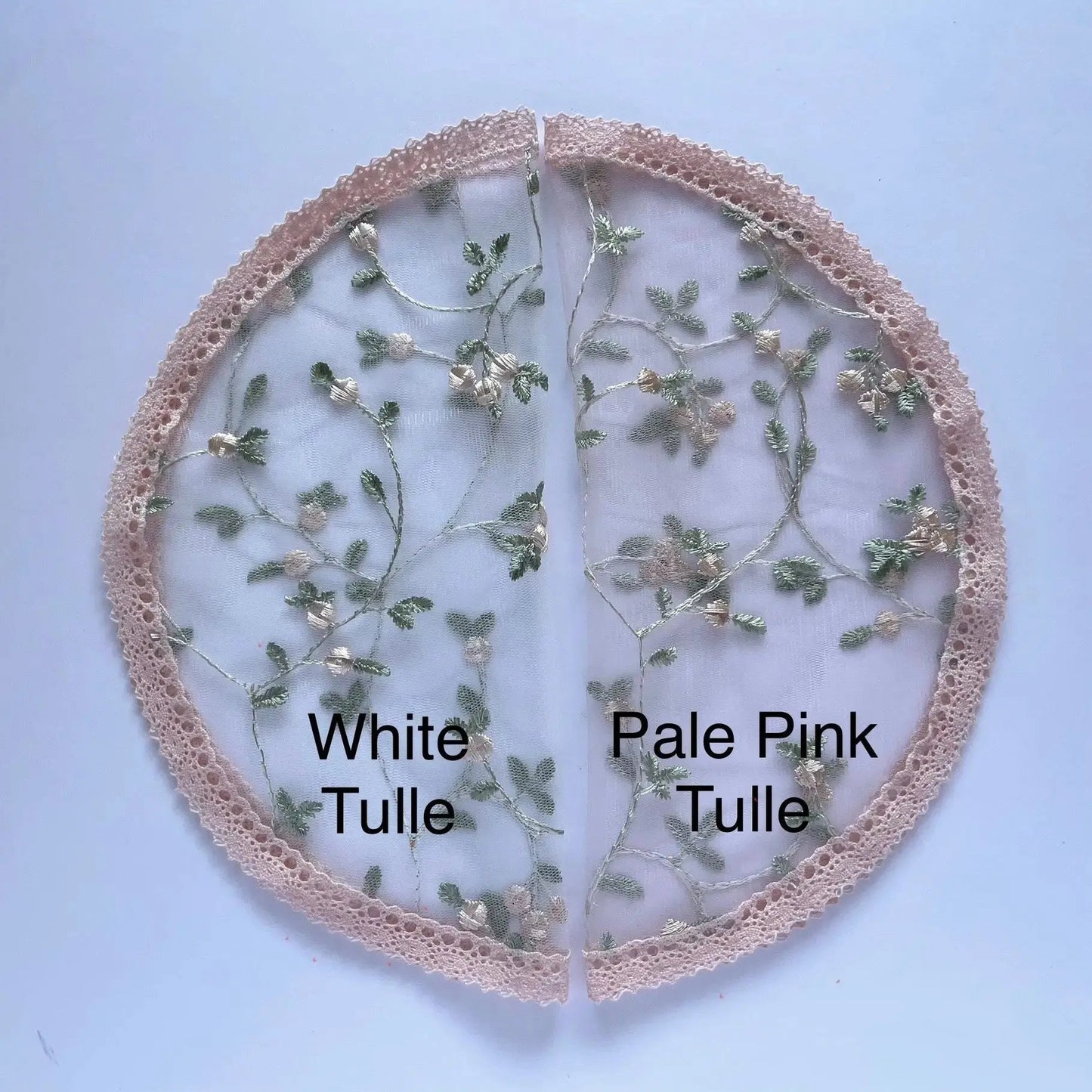 Color swatches of pink floral embroidered fabric in white tulle and pale pink tulle.
