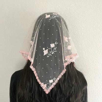  Back view of girl wearing a pink rose embroidered lace triangle chapel veil for Catholic mass.