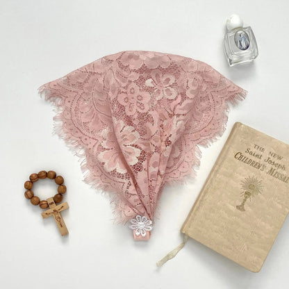 Floral eyelash pink lace newborn veil for a traditional Catholic prayer service.