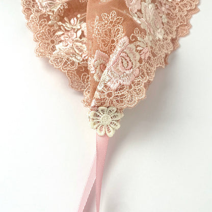 Peach lace chapel veil with ribbon ties and rose embroidery. The small girls veil headband also acts as a kerchief bandana.