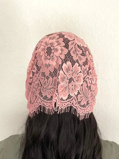 Back view of woman wearing a traditional dark pink eyelash lace Catholic chapel veil kerchief headscarf.