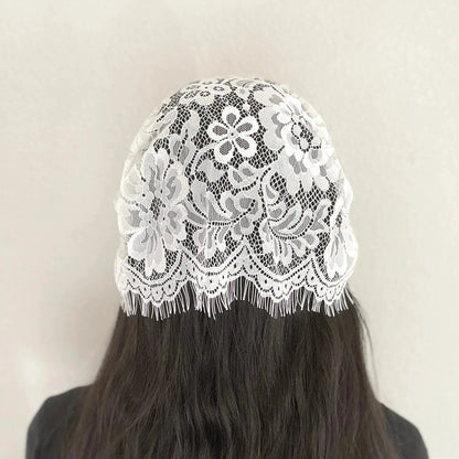 Back of girl wearing a traditional white eyelash lace Catholic chapel veil kerchief.