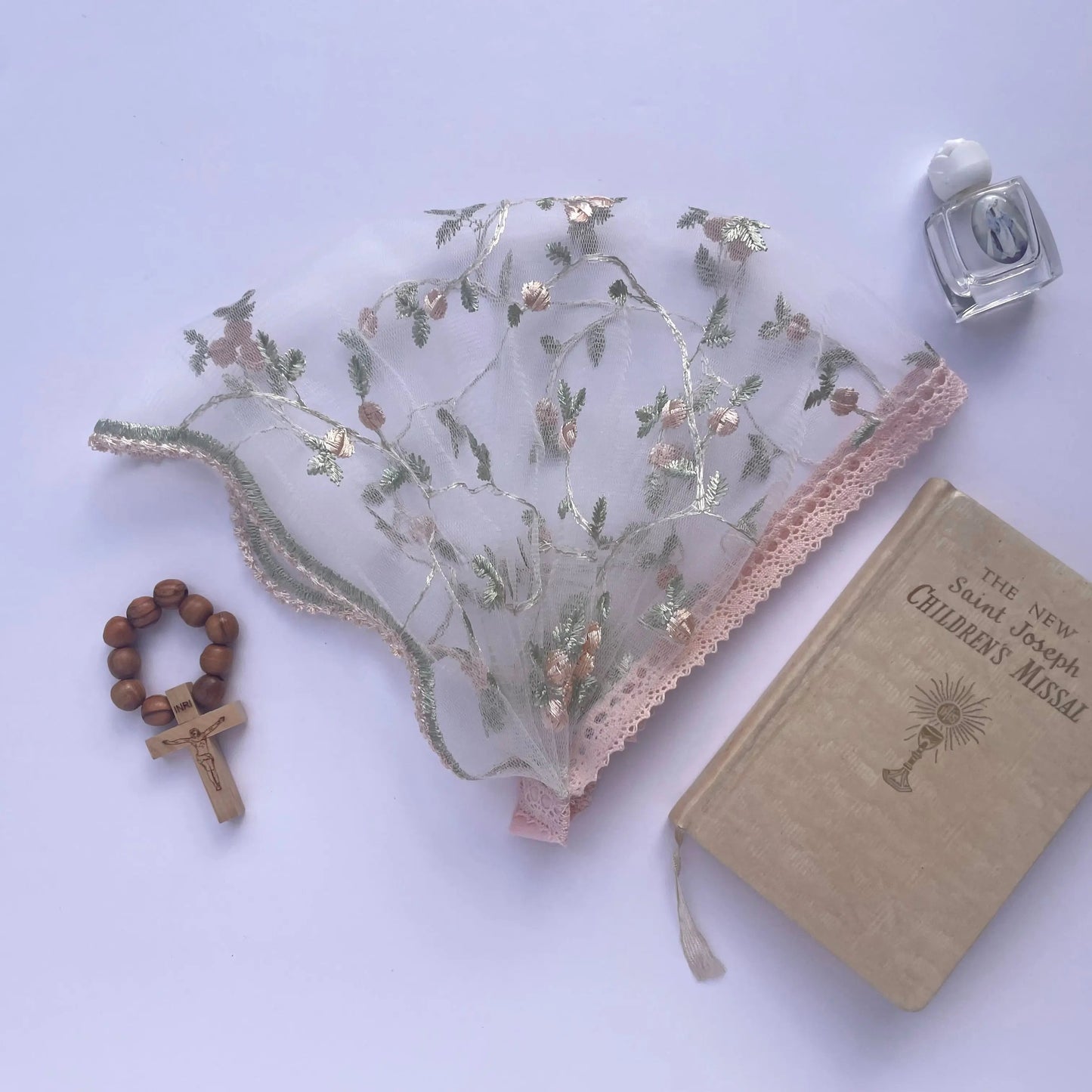 Pale pink lace veil with floral embroidery. The baby or toddler Christian mantilla is perfect for Traditional Catholic Mass