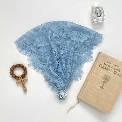 Blue floral eyelash lace newborn veil for a traditional Catholic prayer service.