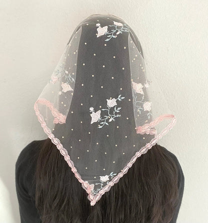 Back view of girl wearing a pink triangle veil with embroidered roses on tulle.