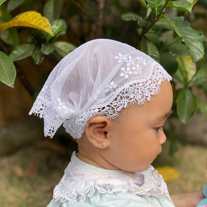 Infant in a ivory white embroidered lace catholic chapel veil for baptism.