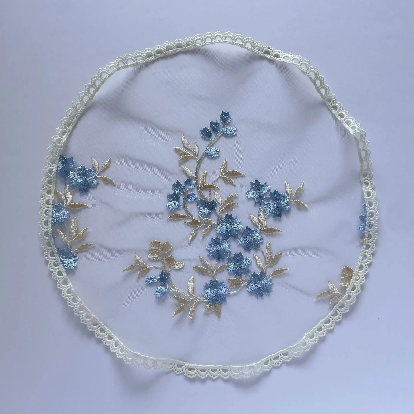 Floral embroidered blue gold lace circular veil for girls at traditional Catholic mass or a prayer service.