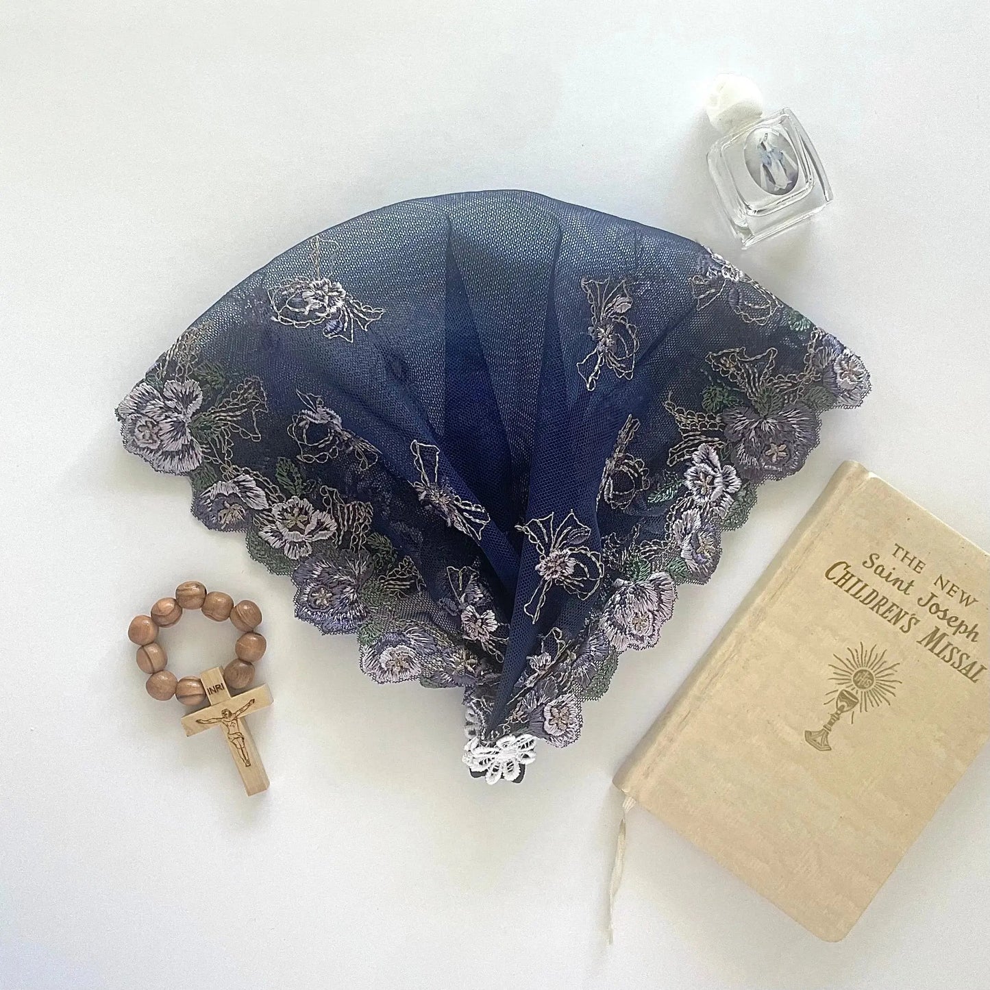 Toddler blue lace chapel veil featuring delicate embroidered floral pattern.