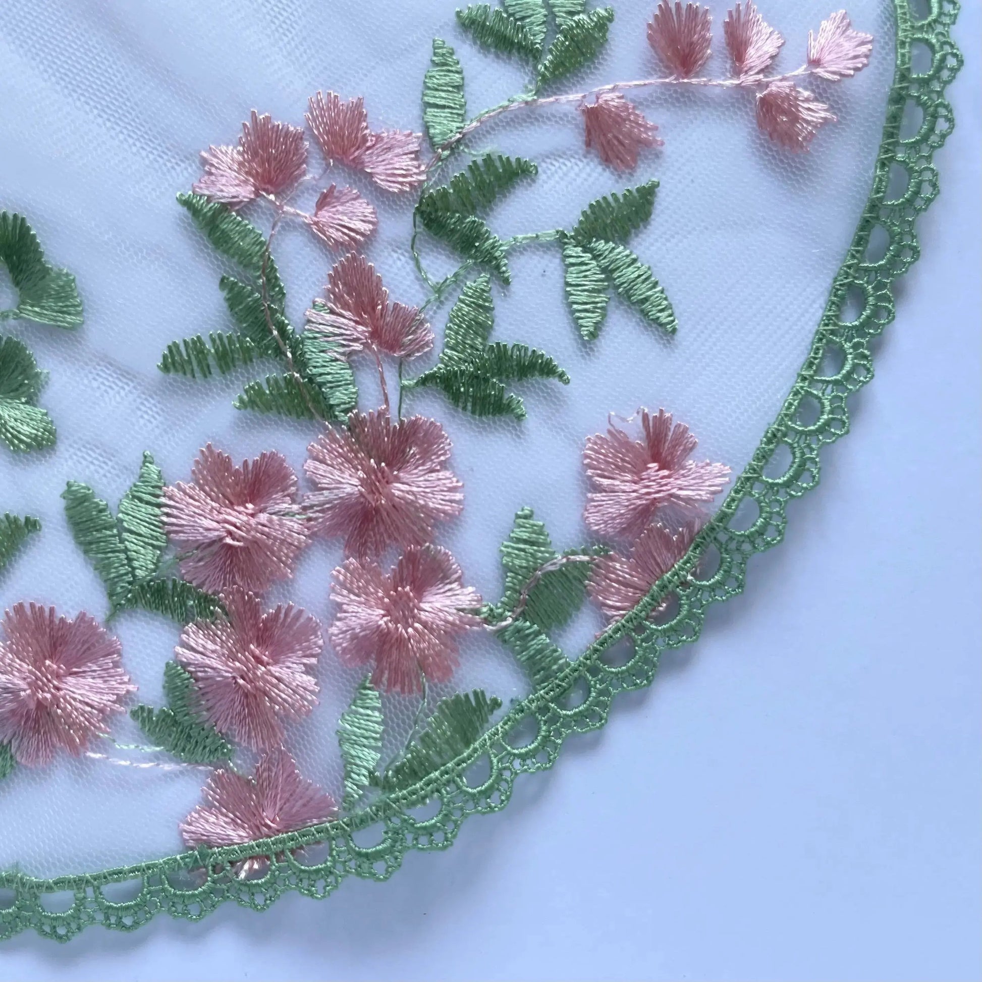 Floral embroidered green pink lace circular veil for girls at traditional Catholic mass or a prayer service.