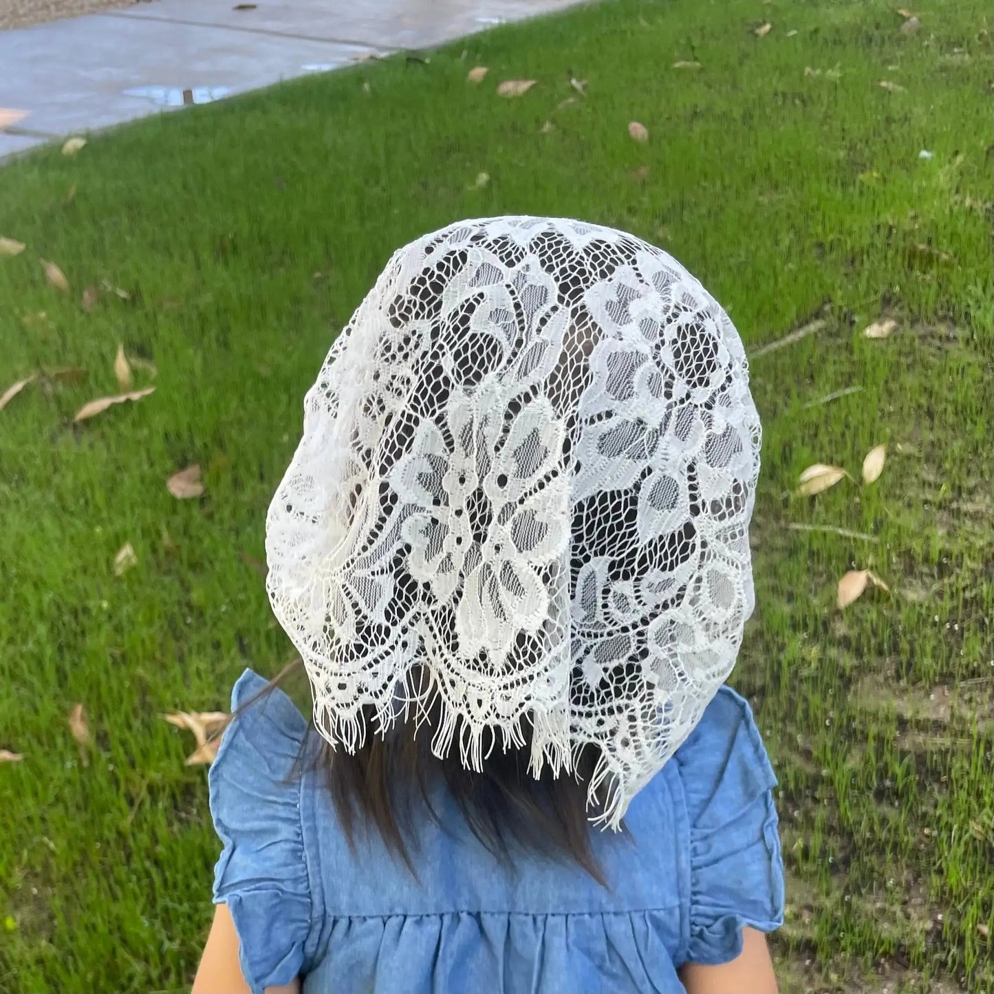 Baby wearing a white colored Catholic Latin Mass veil.