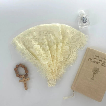 Light yellow floral eyelash lace newborn veil for a traditional Catholic prayer service.